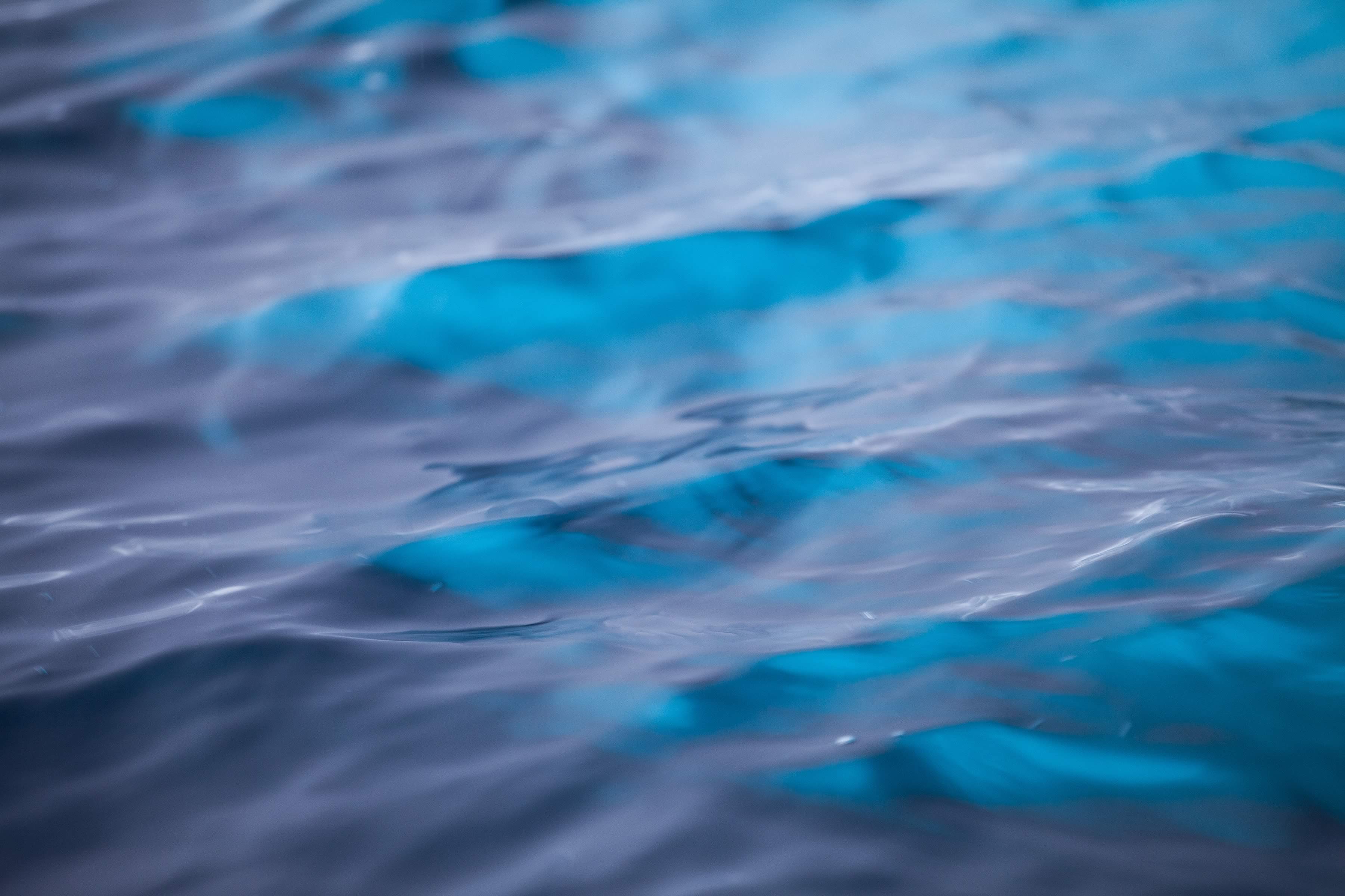 Close up of sea water reflecting the blue from iceberg. Photo: Charles Millen.
